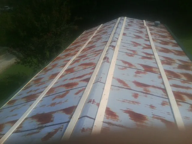 Rusted metal roof panels with new wood purlins before replacement — Storm Damage Roof Repair in Woodbridge by Roofing Brothers